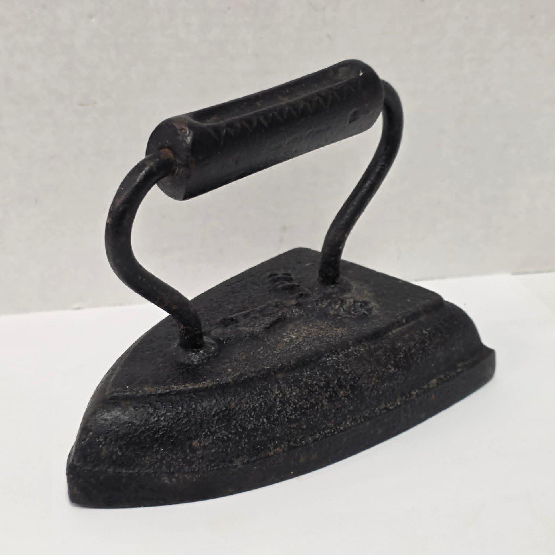 Antique cast iron tailor's press iron made in Guelph Ontario with beautifully formed handle.
