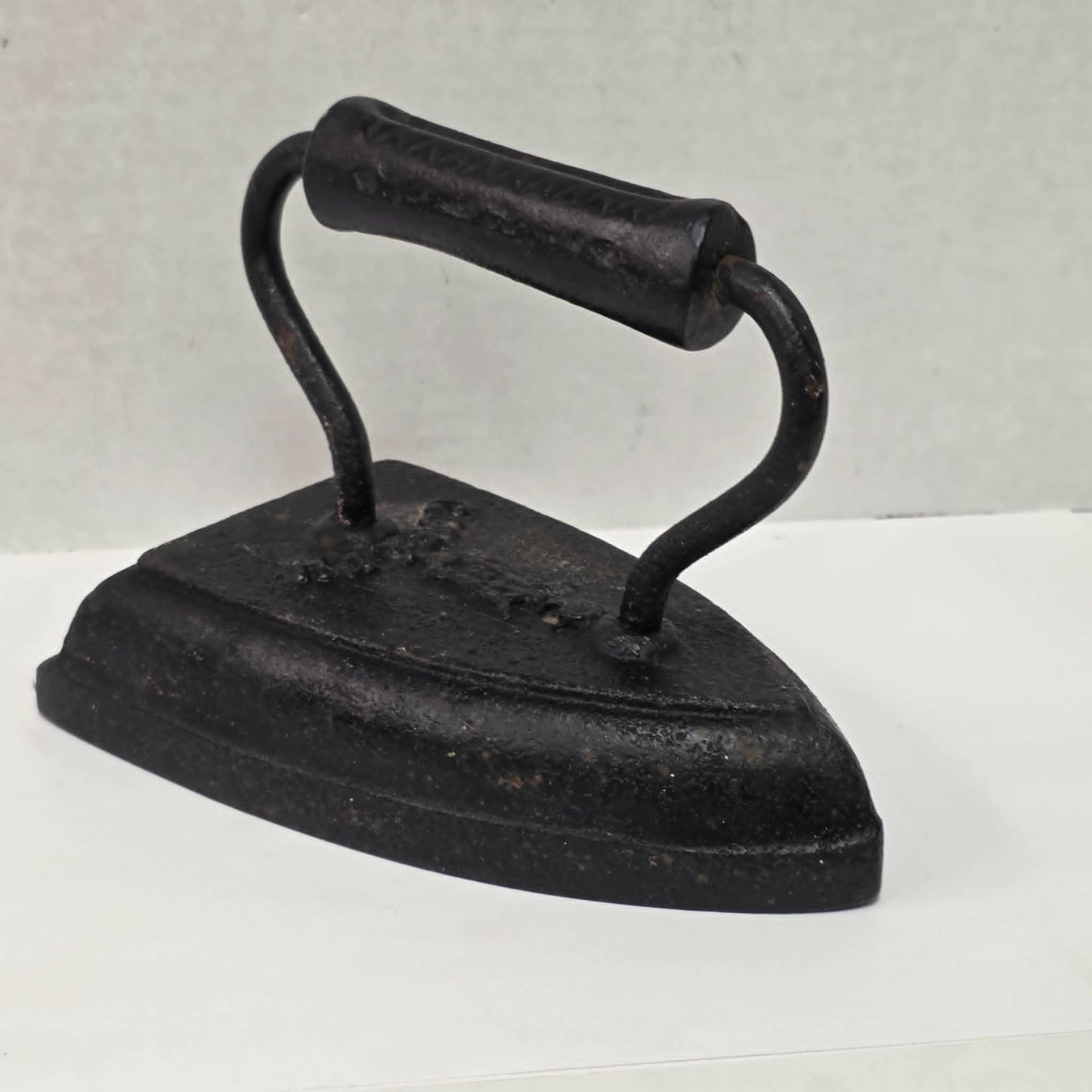 Antique cast iron tailor's press iron made in Guelph Ontario with beautifully formed handle.
