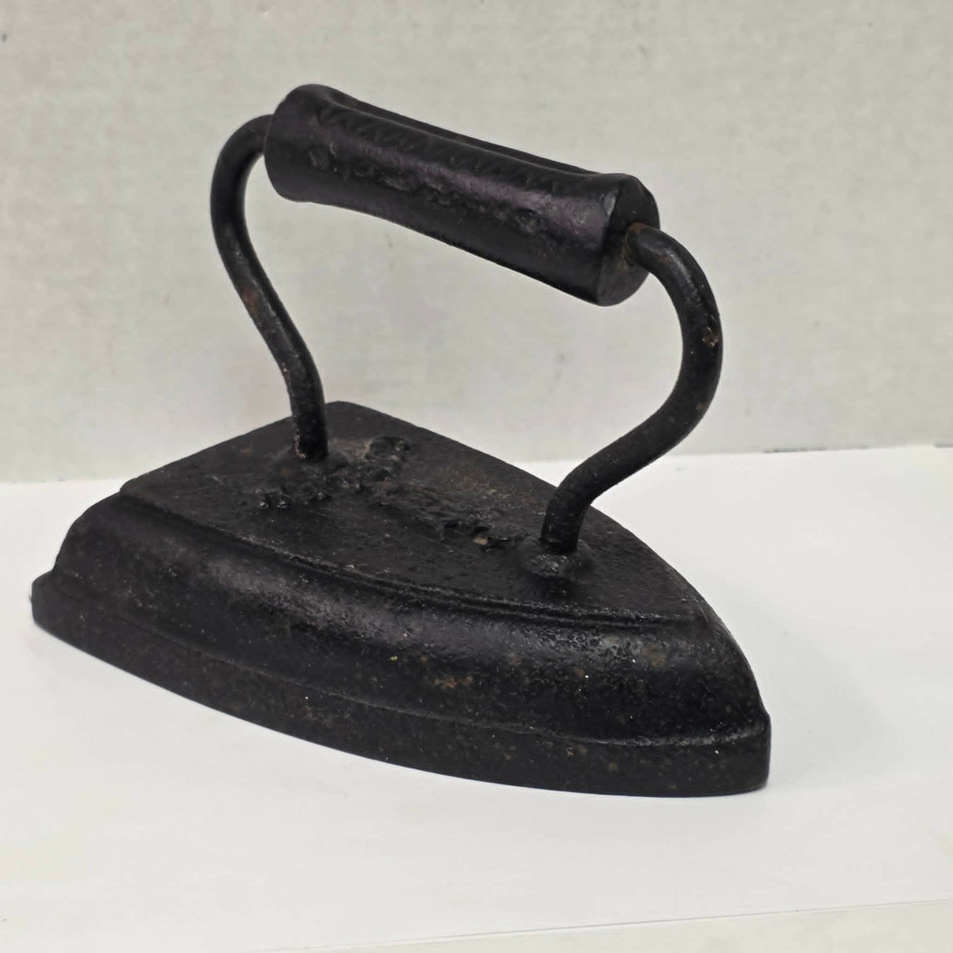 Antique cast iron tailor's press iron made in Guelph Ontario with beautifully formed handle.

