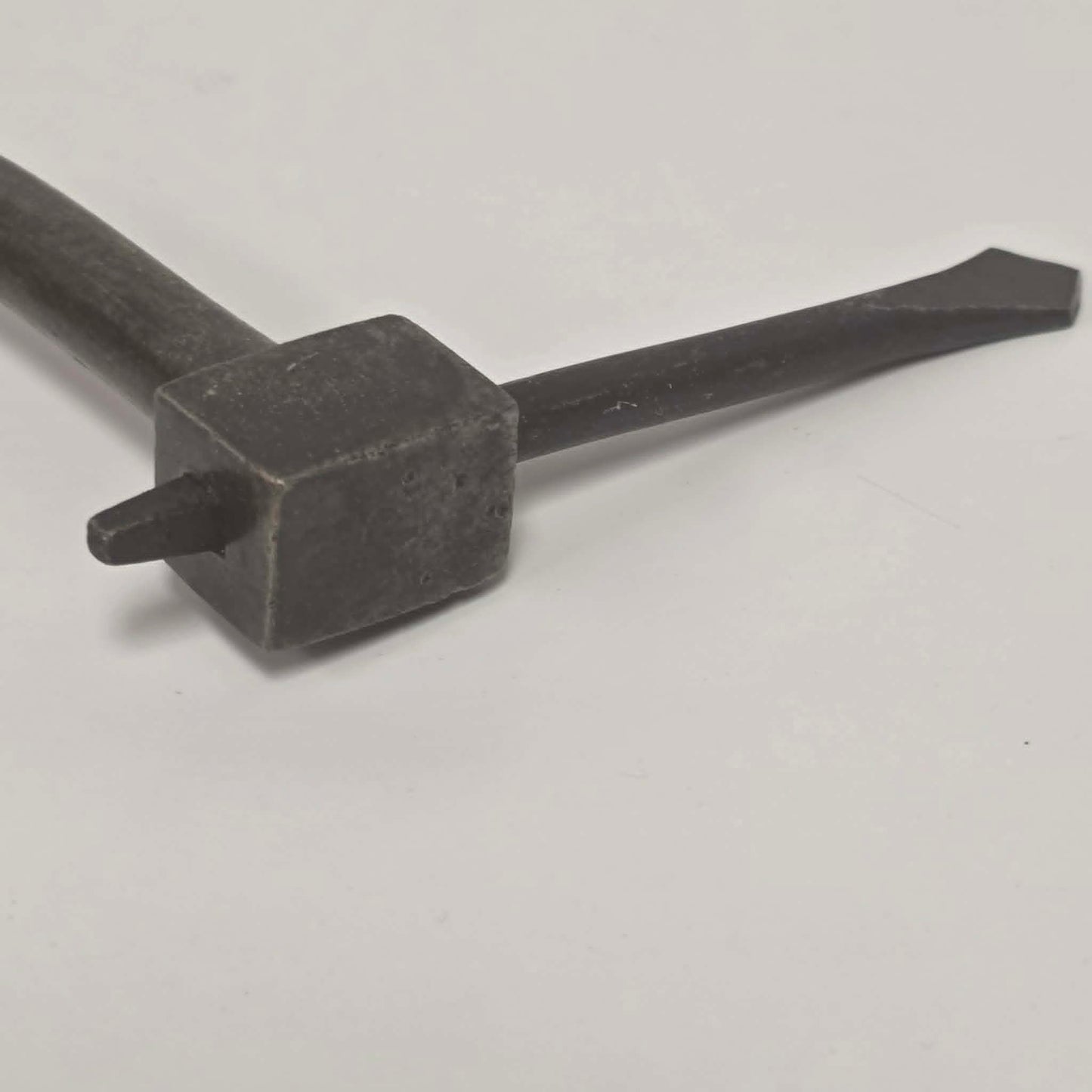 An exquisitely crafted antique walnut-handled bit brace that showcases the beauty and precision of early woodworking tools.
