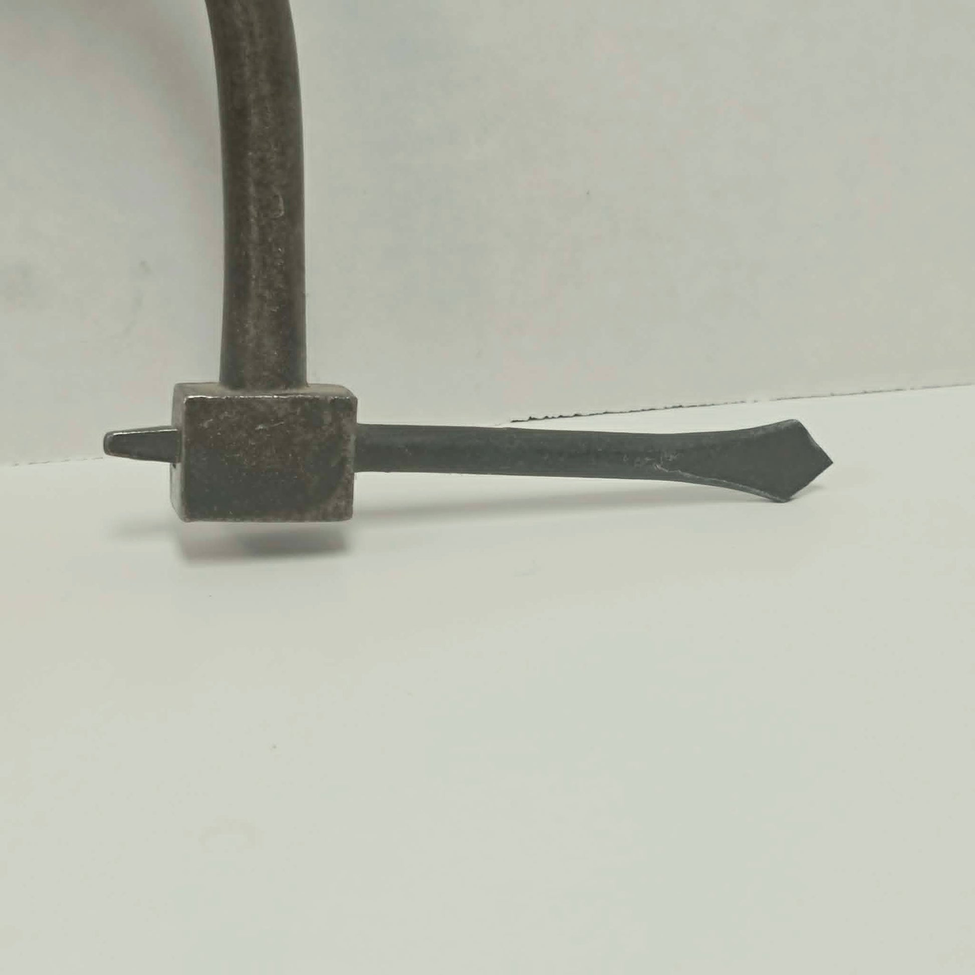 An exquisitely crafted antique walnut-handled bit brace that showcases the beauty and precision of early woodworking tools.
