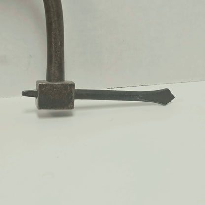 An exquisitely crafted antique walnut-handled bit brace that showcases the beauty and precision of early woodworking tools.
