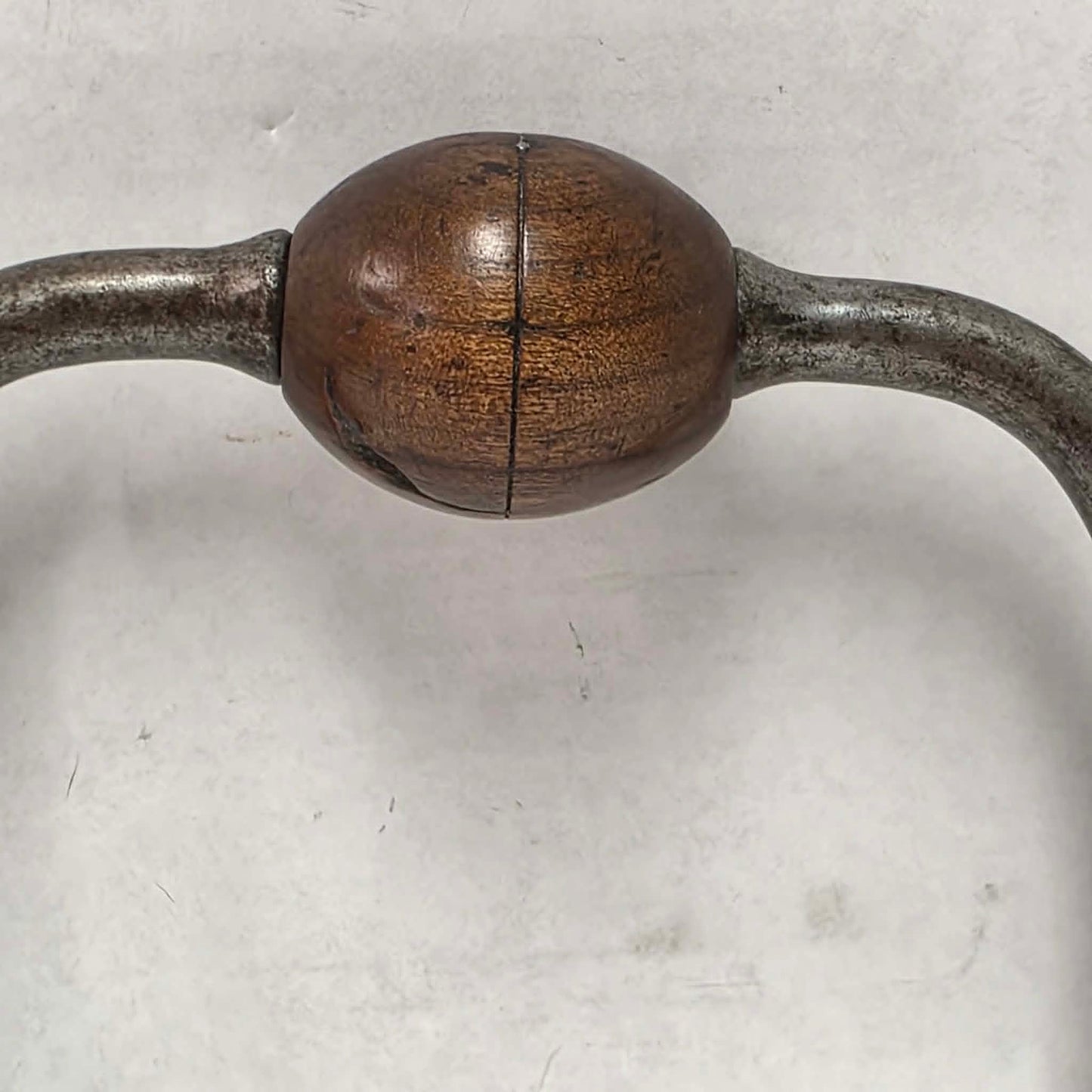 An exquisitely crafted antique walnut-handled bit brace that showcases the beauty and precision of early woodworking tools.
