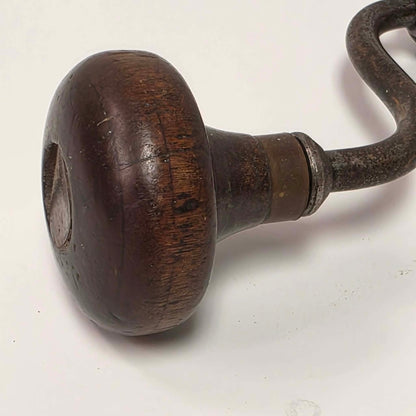 Antique primitive carpenter's bit brace with wood and brass handle.
