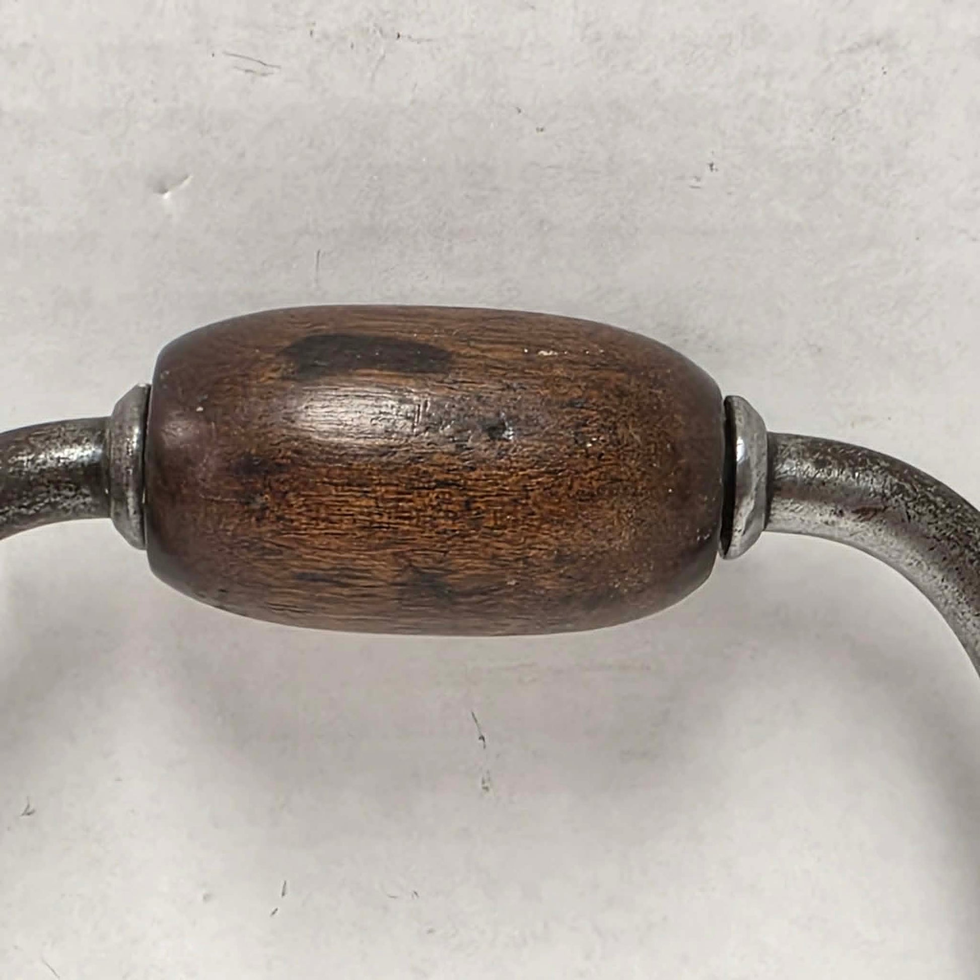 Antique primitive carpenter's bit brace with wood and brass handle.
