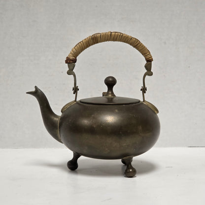 Dainty primitive brass teapot with rattan handle
