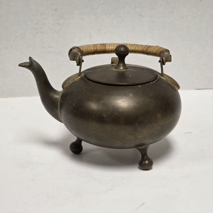Dainty primitive brass teapot with rattan handle
