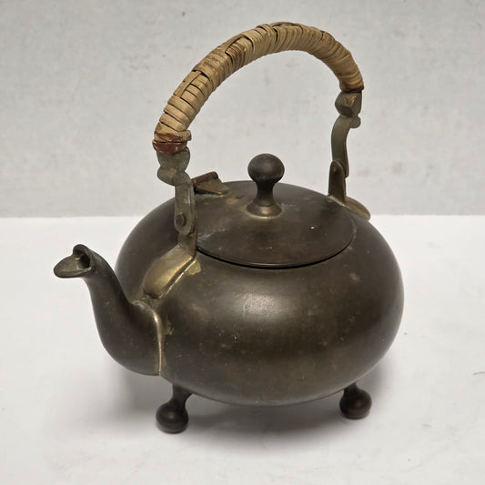 Dainty primitive brass teapot with rattan handle
