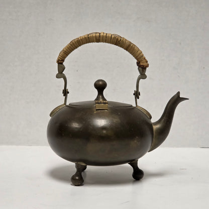 Dainty primitive brass teapot with rattan handle
