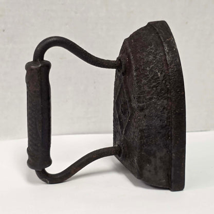 Antique Taylor Forbes No. 6 cast iron sad iron with diamond marking and patterned handle.

