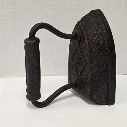 Antique Taylor Forbes No. 6 cast iron sad iron with diamond marking and patterned handle.
