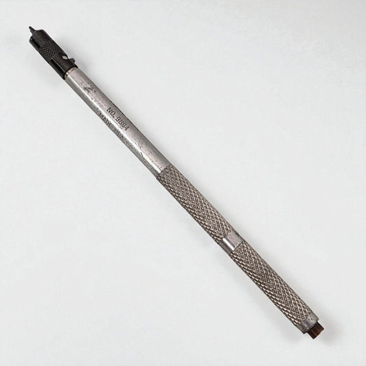Metal tool with textured grip on a white background