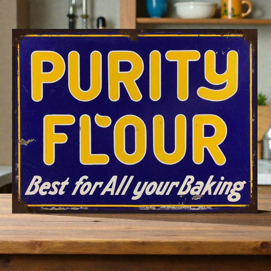 Vintage-style 'Purity Flour' sign with yellow text on a blue background, placed on a wooden surface.