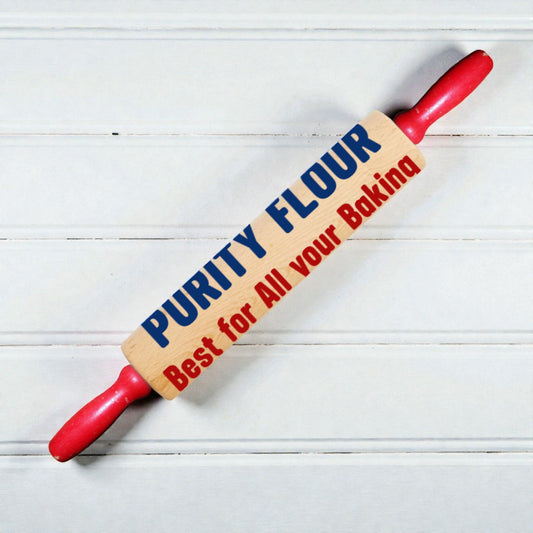 Red rolling pin with 'Purity Flour' branding on a light wooden background