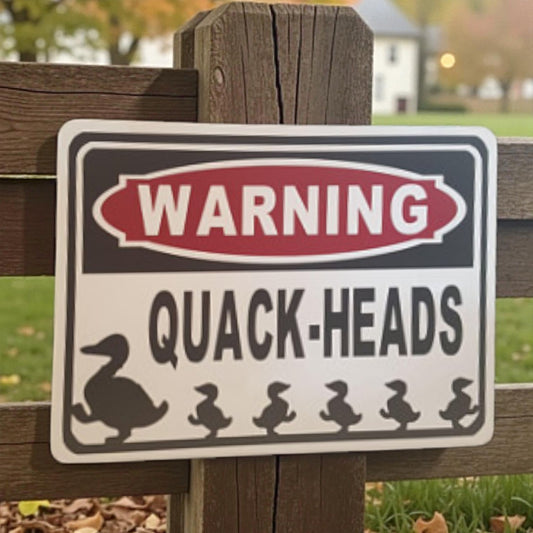 Warning sign with duck illustrations on a wooden fence