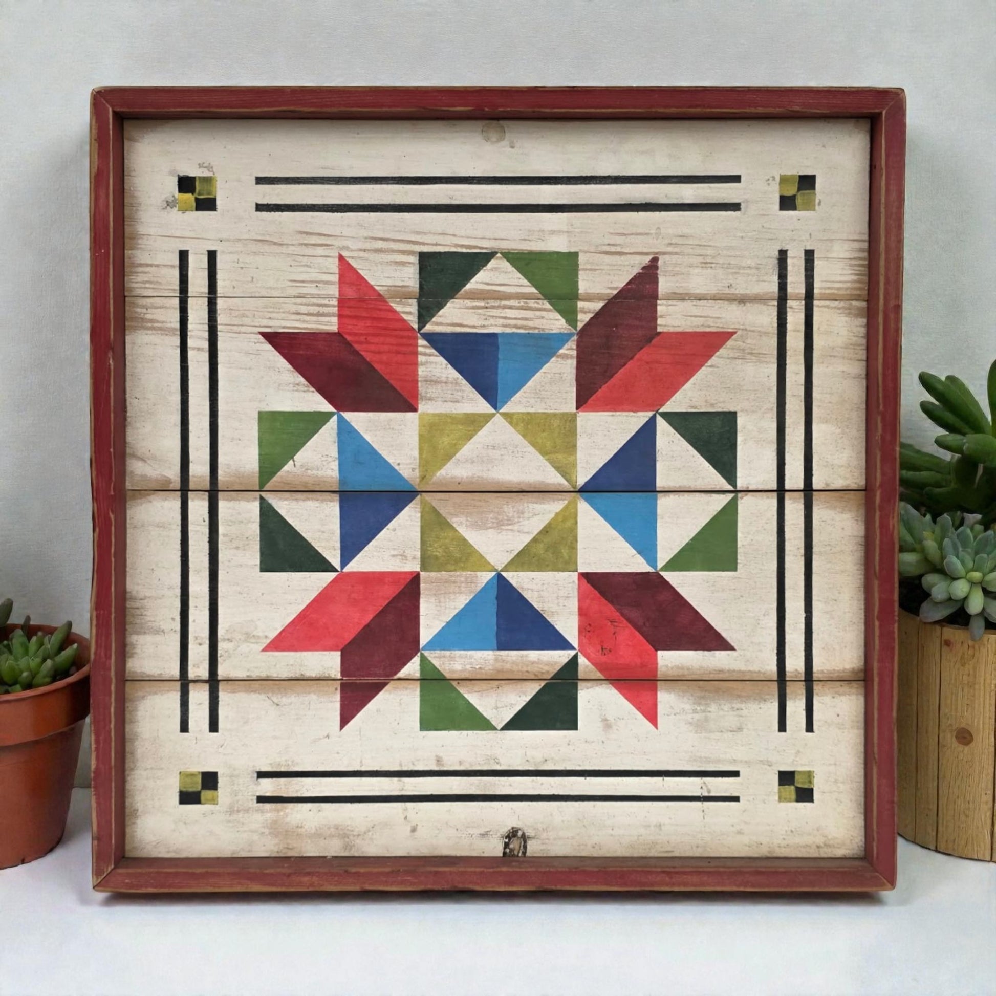 Wooden wall art with geometric star design in red, blue, green, and yellow, framed in brown.