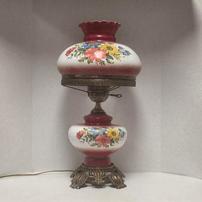 Vintage Gone with the Wind hurricane lamp with red and white floral glass and tri-light feature.
