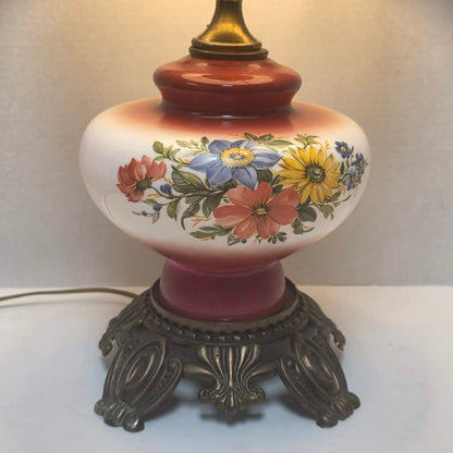 Vintage Gone with the Wind hurricane lamp with red and white floral glass and tri-light feature.
