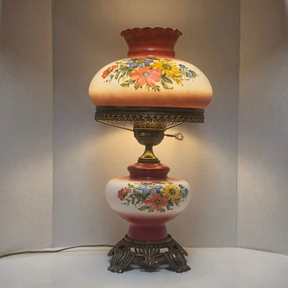 Vintage Gone with the Wind hurricane lamp with red and white floral glass and tri-light feature.
