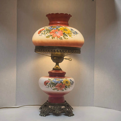 Vintage Gone with the Wind hurricane lamp with red and white floral glass and tri-light feature.
