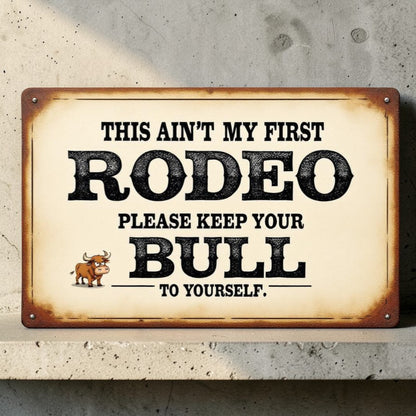 Vintage-style sign with humorous rodeo-themed text on a concrete wall.