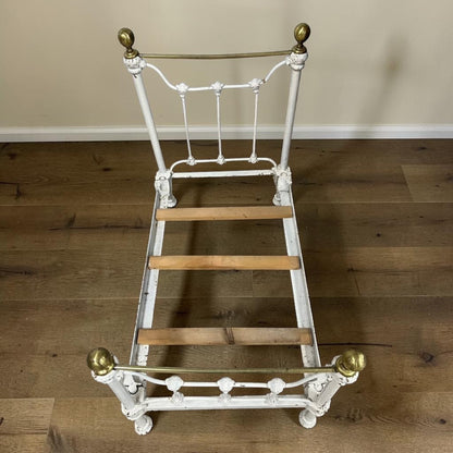A charming Victorian iron and brass miniature bed from a bygone era.
