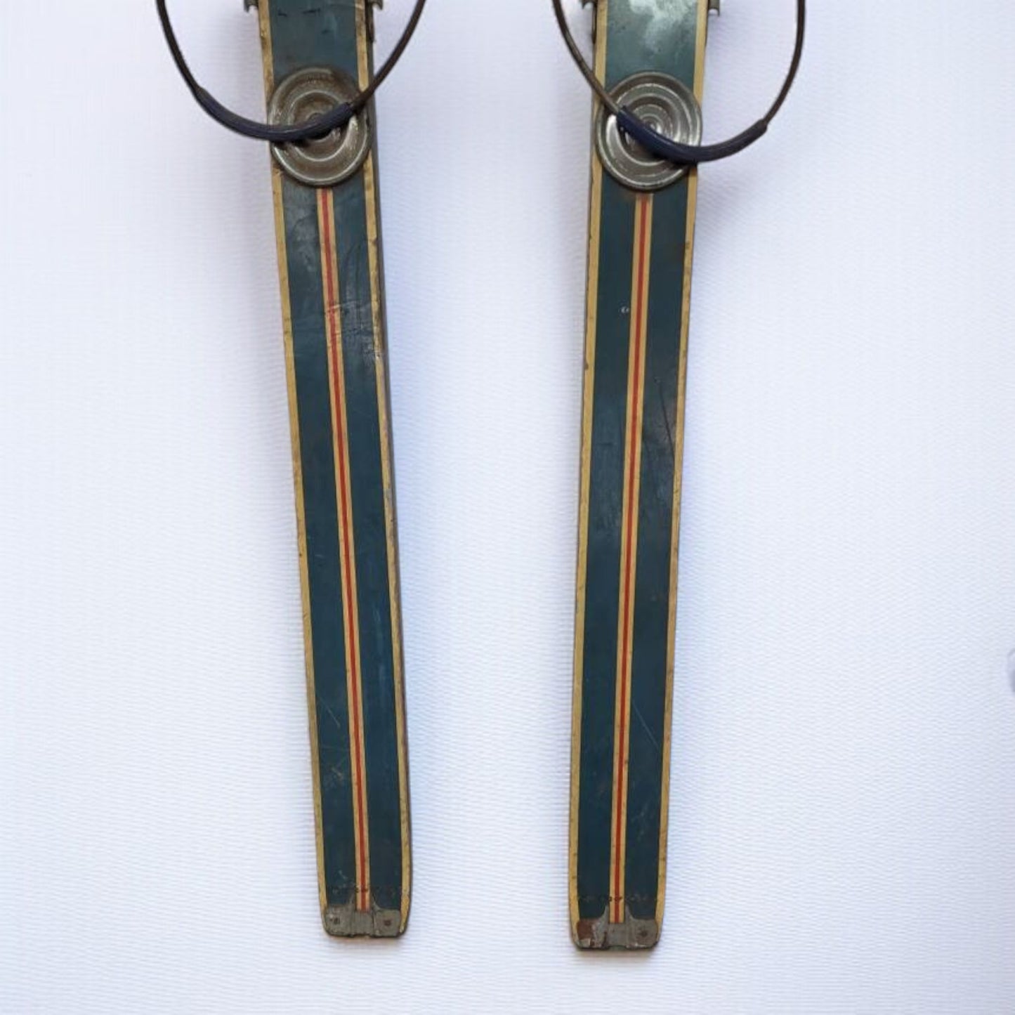 Two vintage skis with bindings on a white background