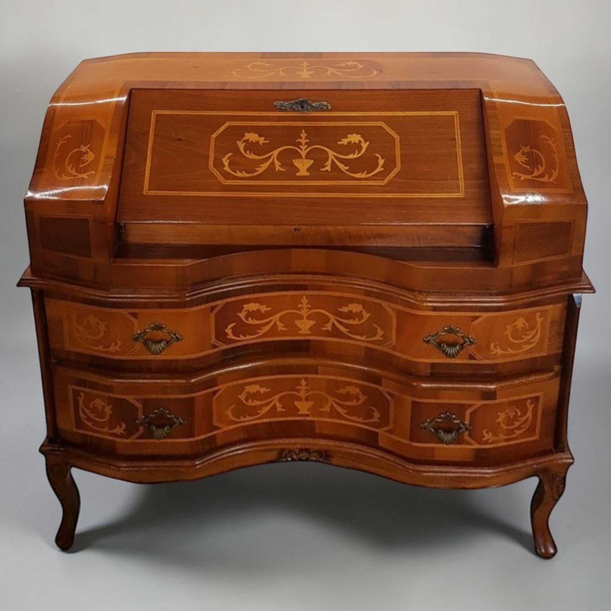 Louis XVI-style inlaid marquetry writing desk with walnut and fruitwood, featuring drop-down surface and interior drawers.