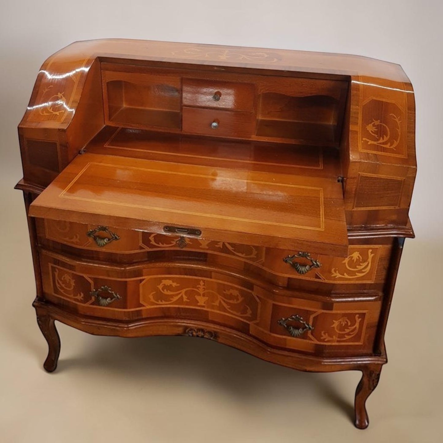 Louis XVI-style inlaid marquetry writing desk with walnut and fruitwood, featuring drop-down surface and interior drawers.