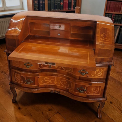Louis XVI-style inlaid marquetry writing desk with walnut and fruitwood, featuring drop-down surface and interior drawers.