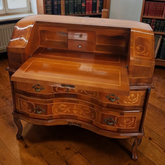 Louis XVI-style inlaid marquetry writing desk with walnut and fruitwood, featuring drop-down surface and interior drawers.