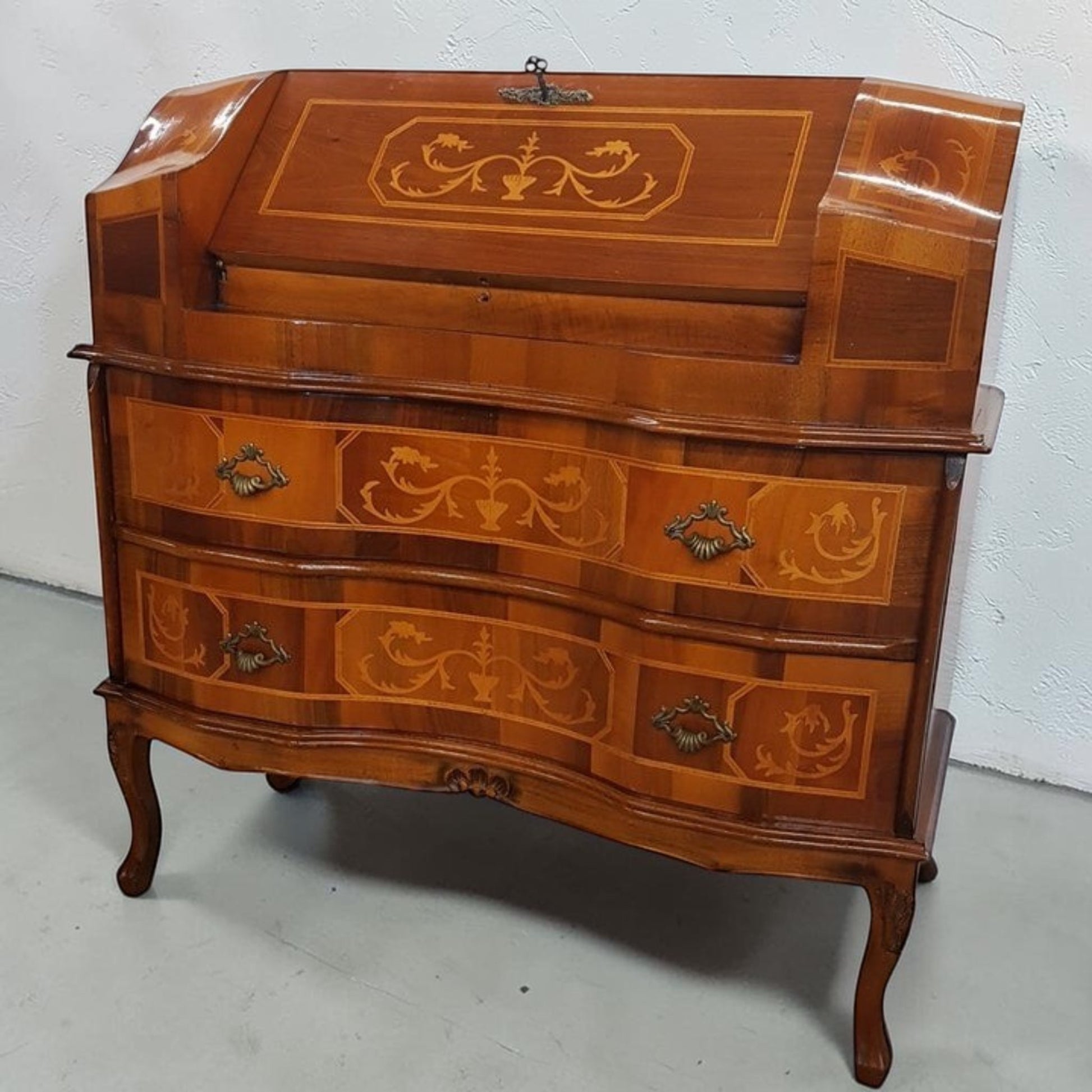 Louis XVI-style inlaid marquetry writing desk with walnut and fruitwood, featuring drop-down surface and interior drawers.