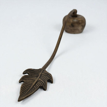 Bronze leaf-shaped object on a white background