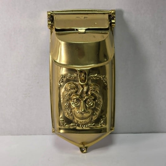 Vintage solid brass mailbox with ornate lion head front detail and dual access flaps.