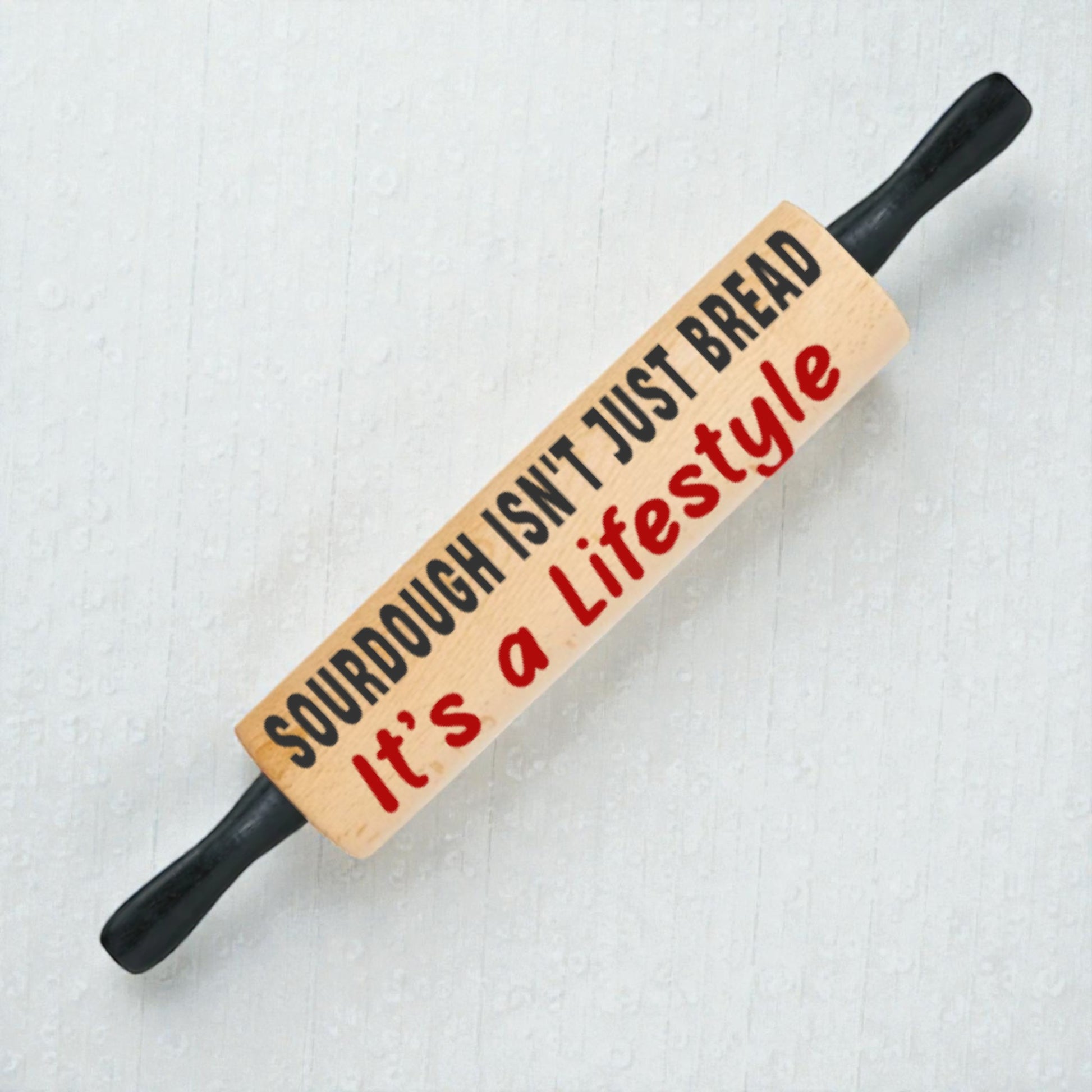 Wooden rolling pin with text on a light background