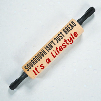 Wooden rolling pin with text on a white background