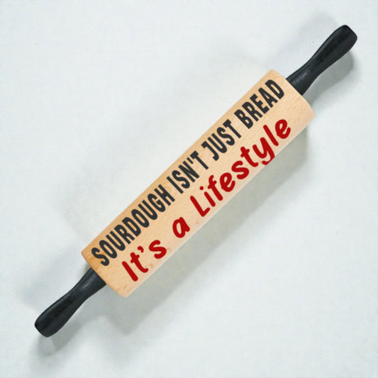 Rolling pin with a humorous message on a light background