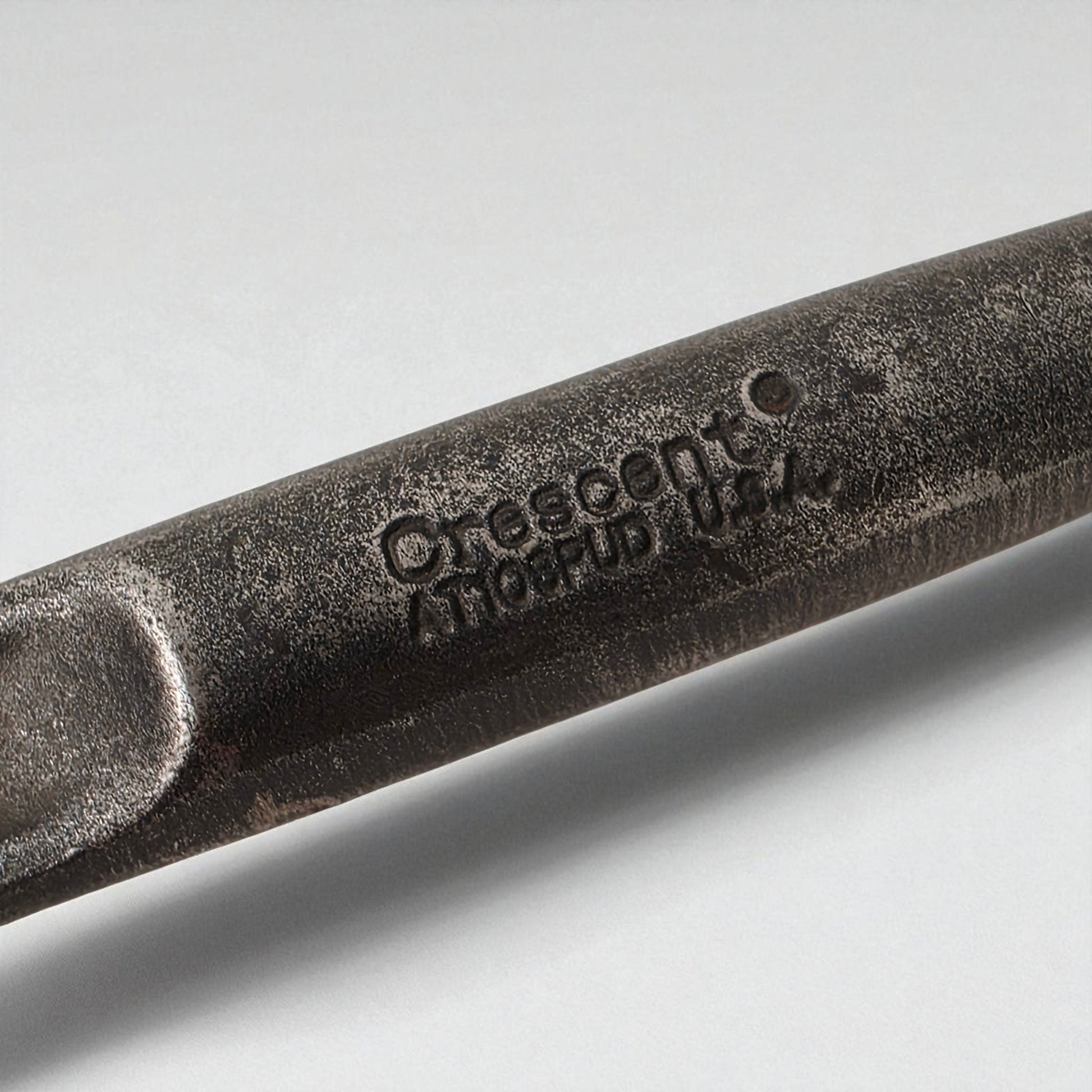 Close-up of a tool with cresent branding on a light gray background