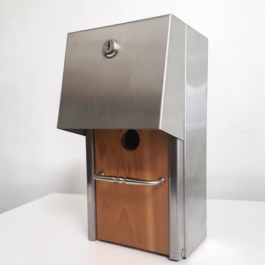 Handmade stainless steel birdhouse with sleek architectural styling and locking access door.