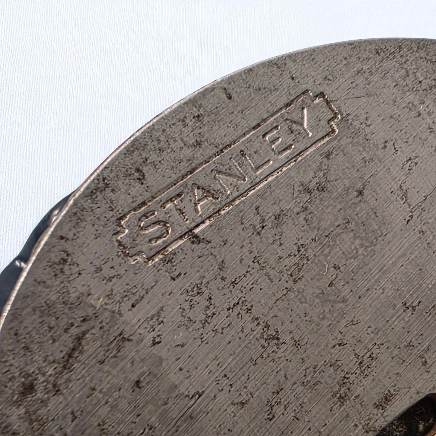 Close-up of a metal object with 'Stanley' branding on a white background