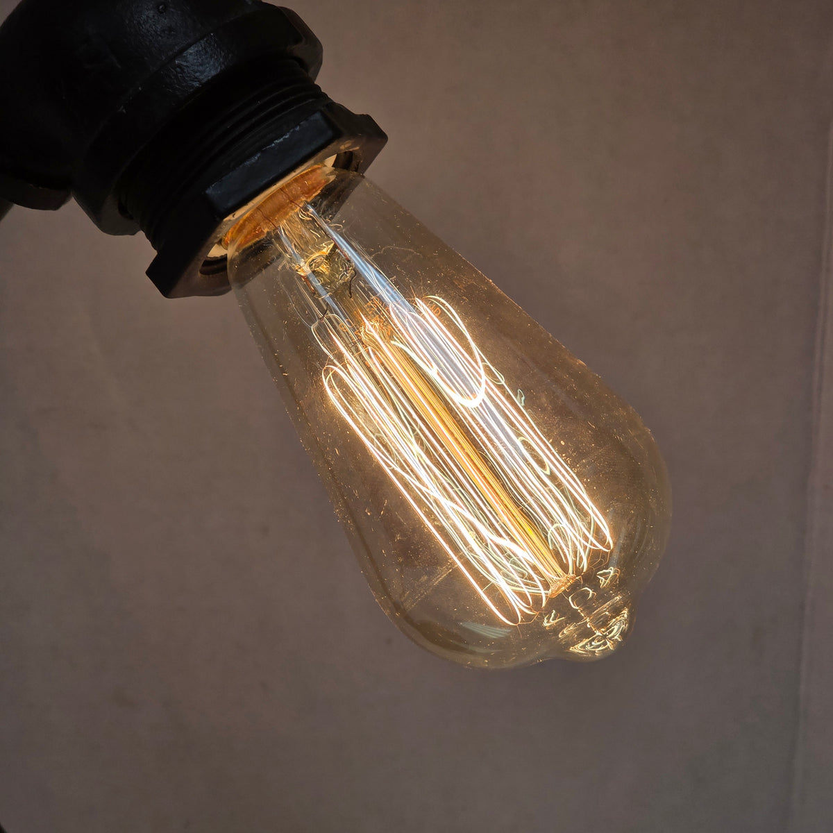 Industrial plumbing pipe lamp with vintage Edison bulb