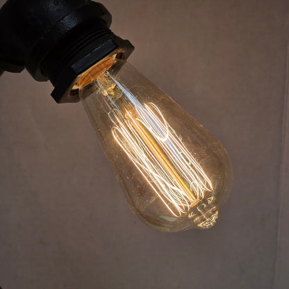 Industrial plumbing pipe lamp with vintage Edison bulb