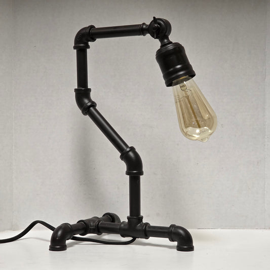 Industrial steampunk desk lamp featuring retro plumbing pipe design and Edison bulb