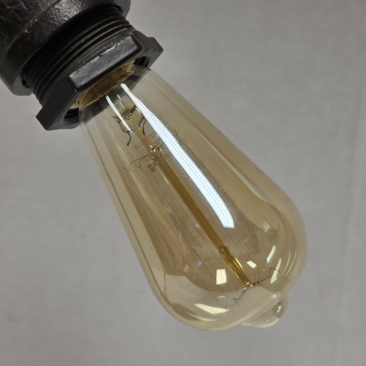 Industrial steampunk desk lamp featuring retro plumbing pipe design and Edison bulb