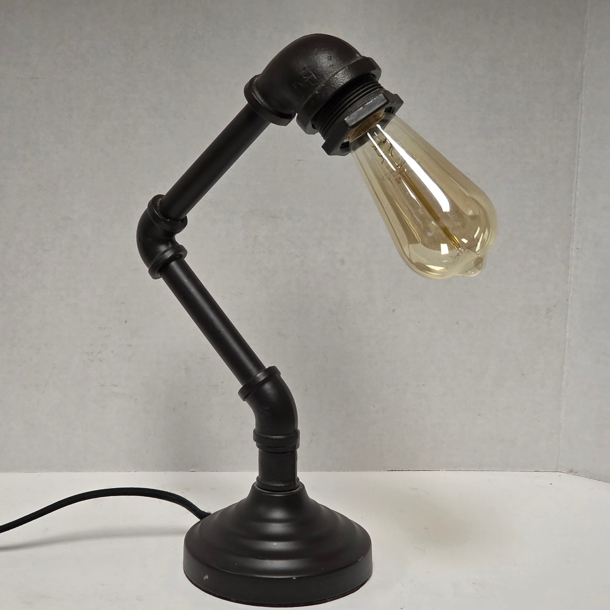 Industrial plumbing pipe lamp with vintage Edison bulb