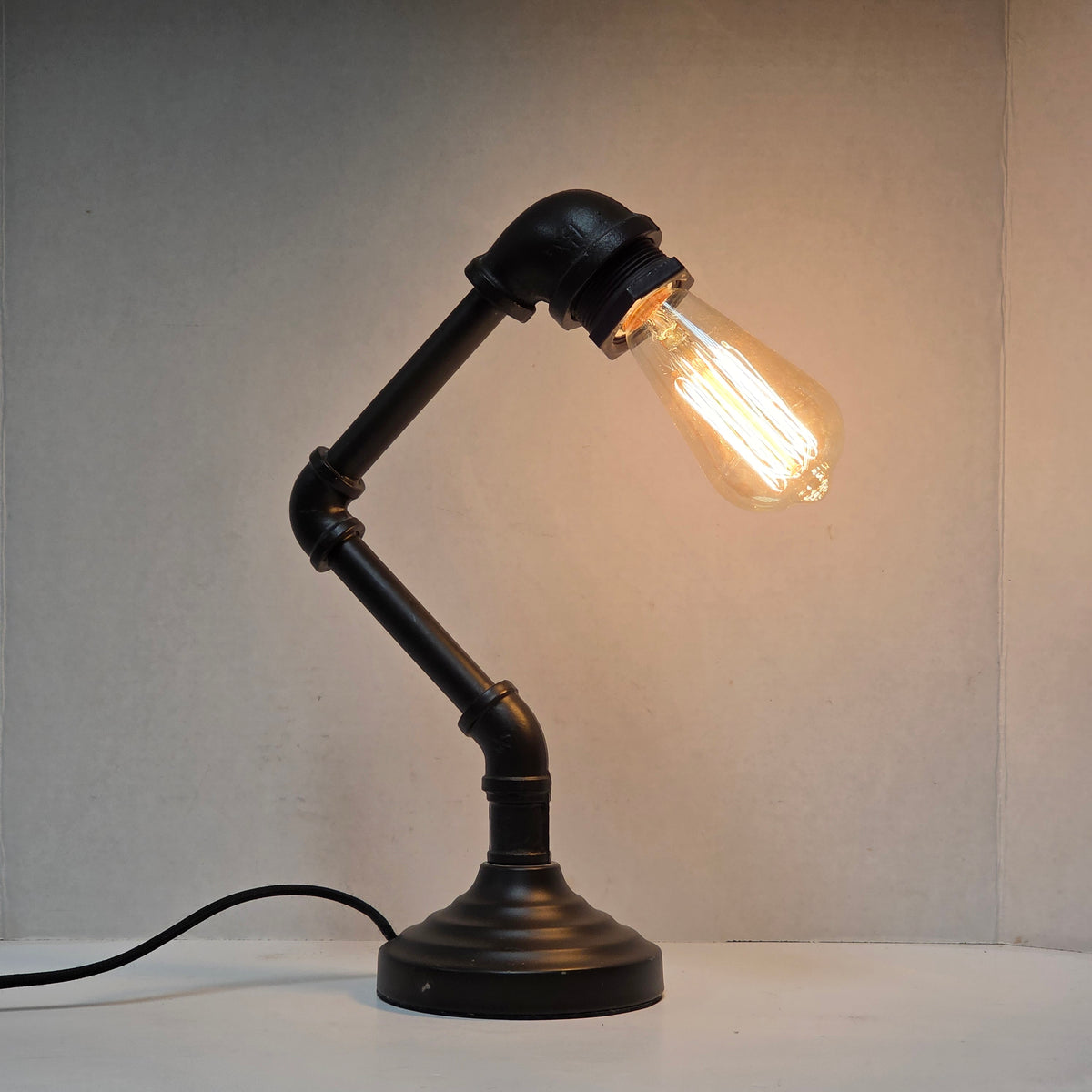 Industrial plumbing pipe lamp with vintage Edison bulb