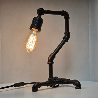 Industrial steampunk desk lamp featuring retro plumbing pipe design and Edison bulb
