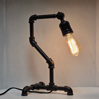 Industrial steampunk desk lamp featuring retro plumbing pipe design and Edison bulb