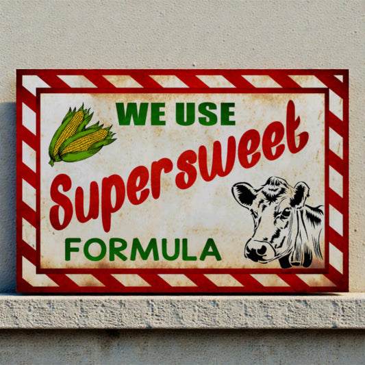 Vintage-style sign with a cow illustration and text about 'Supersweet Formula' on a plain background.