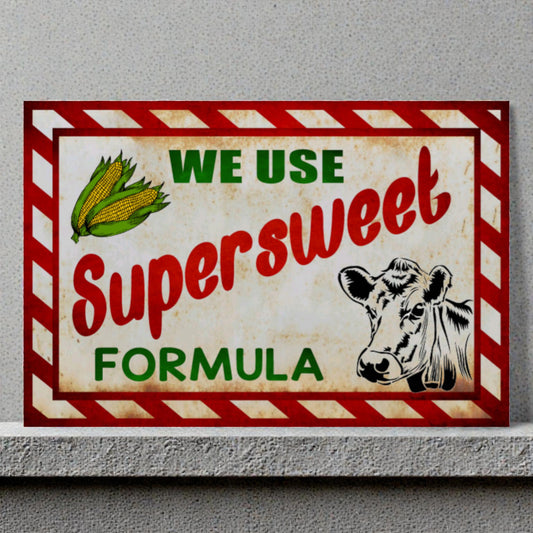 Vintage-style sign with a cow illustration and text about 'Supersweet Formula' on a gray background.